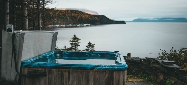Professional movers transporting a hot tub to its new location
