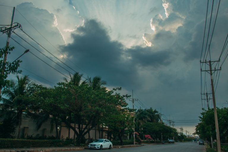Vehicle traveling on a Florida road beneath cloudy skies